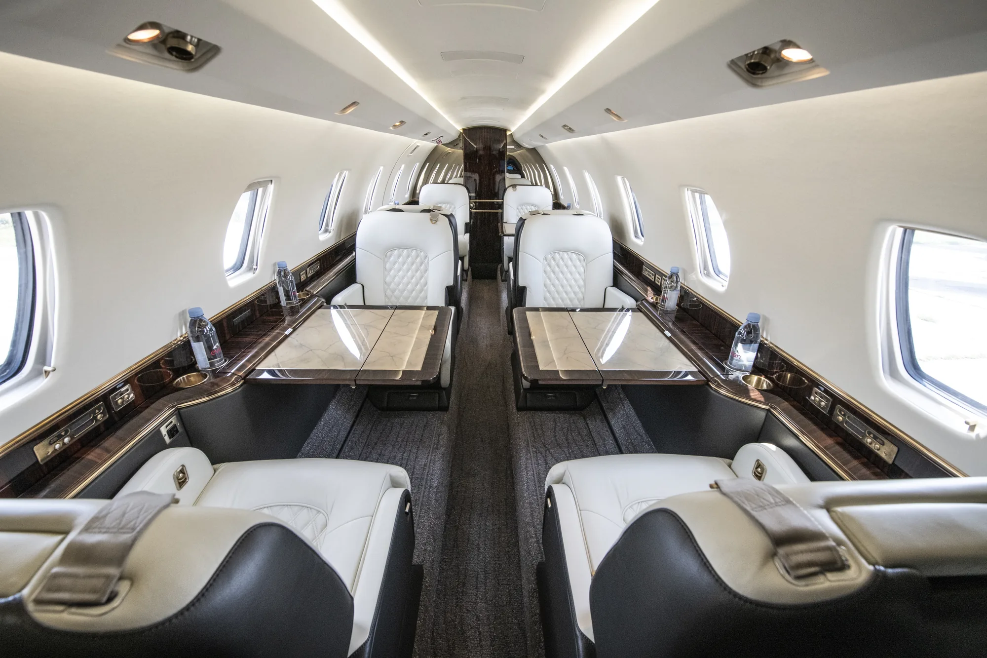 Citation X interior looking aft, double club seating in cream leather