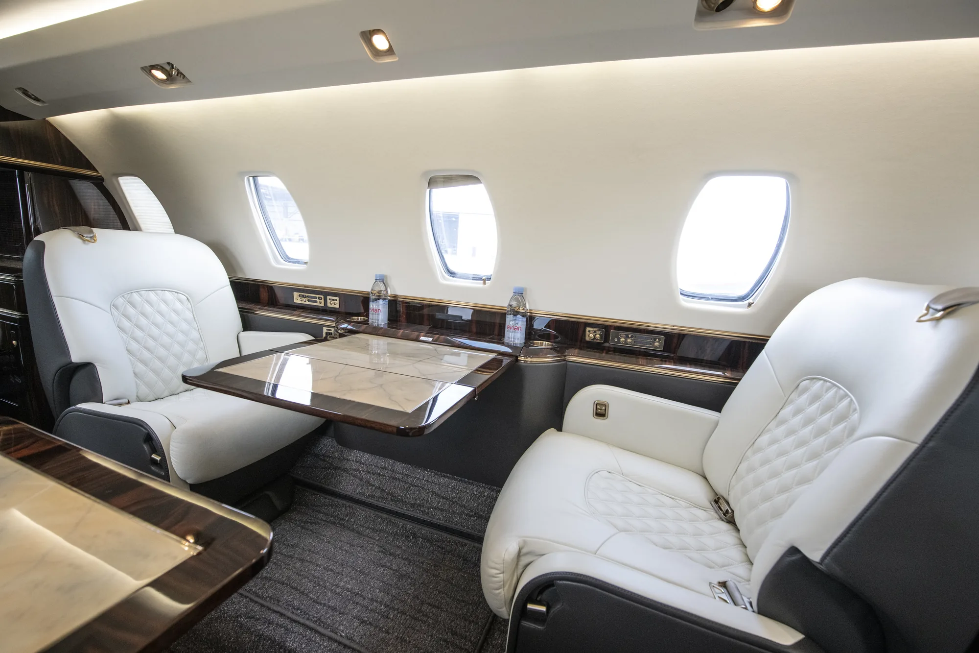 Citation X cabin seats and table beside the cabin windows