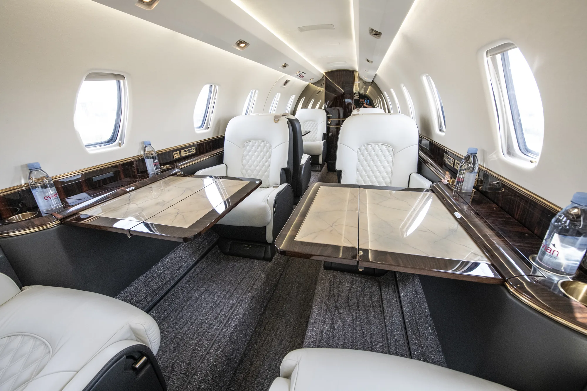 Citation X cabin with marble-topped tables extended between facing seats