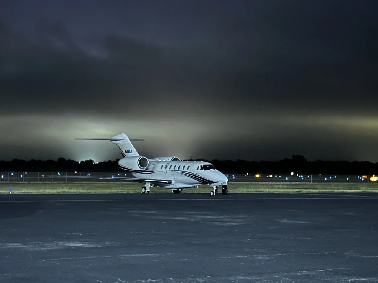 Cessna Citation X on a dark ramp at dusk, fractional jet ownership with Jet Corp